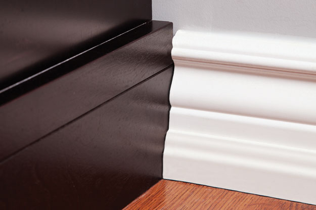 Elevate a simple slide-in, electrical fireplace by installing trim around it.